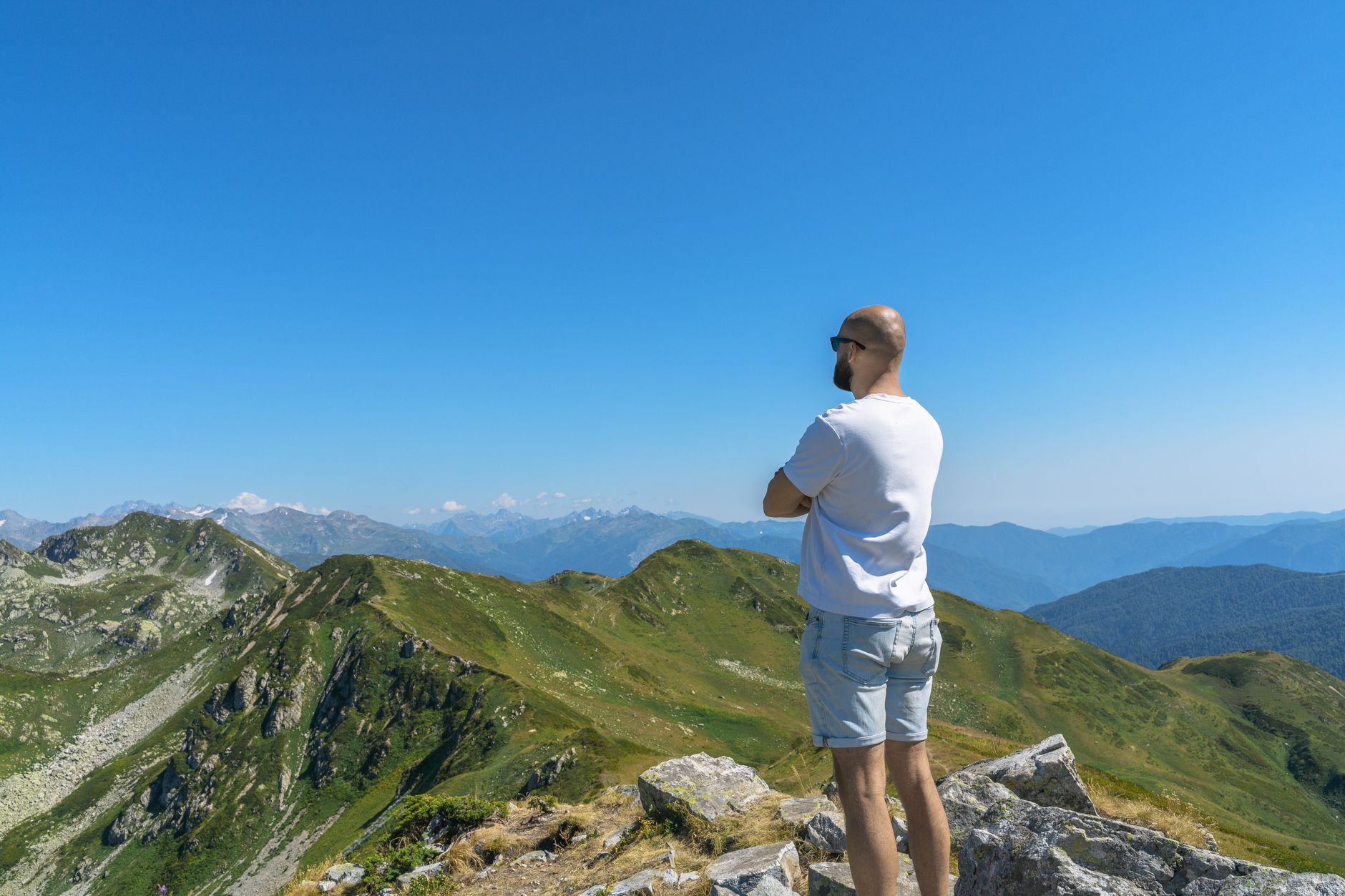 Traveler observing mountain range at dusk