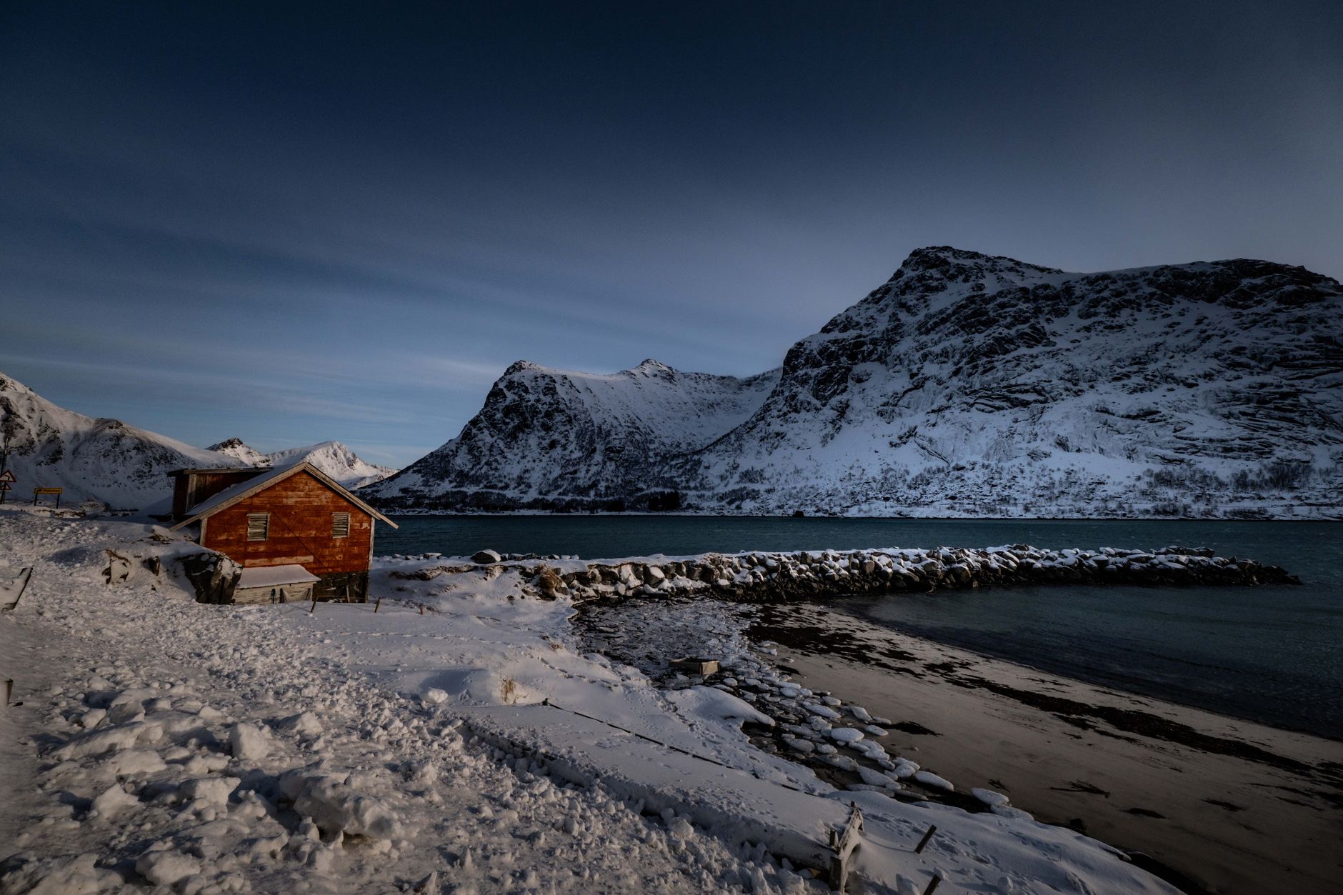 Cozy timber lodge interior with sweeping fjord vista