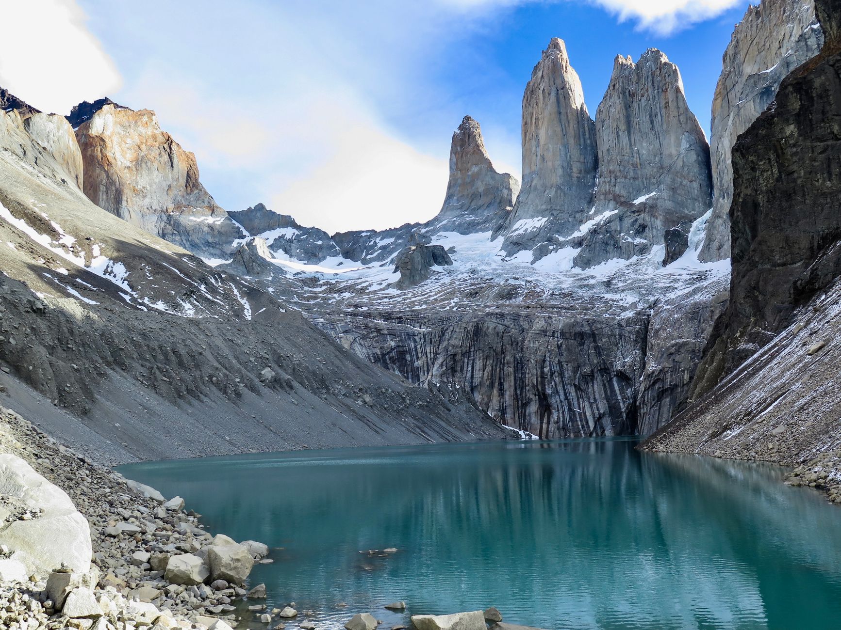 Rugged peaks reflected in cold mountain lake