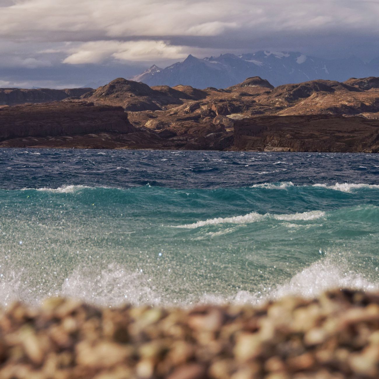 Dramatic windswept lake and mountain horizon